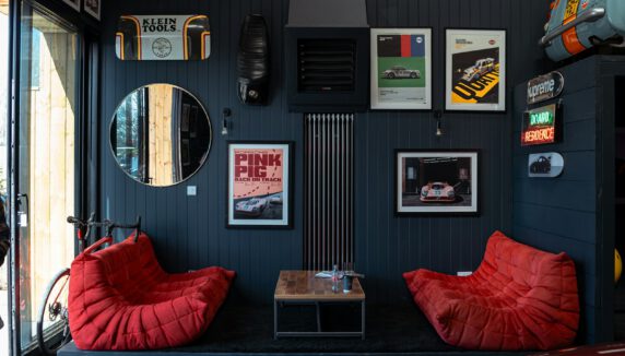 Cozy room with two red chairs and car memorabilia.