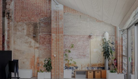 A spacious room with exposed brick walls.